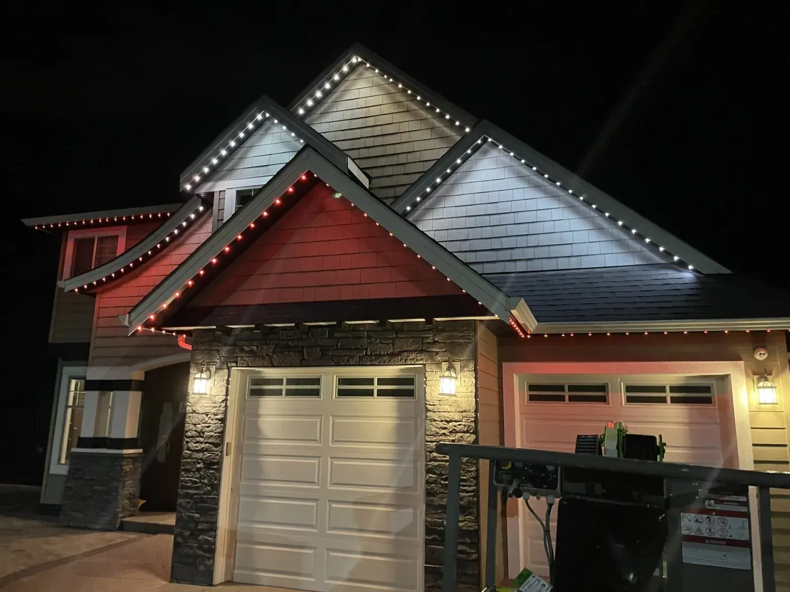 Permanent LED lights alternating red and white along the gables and eaves of a home at night - Christmas preset by Forever Lights